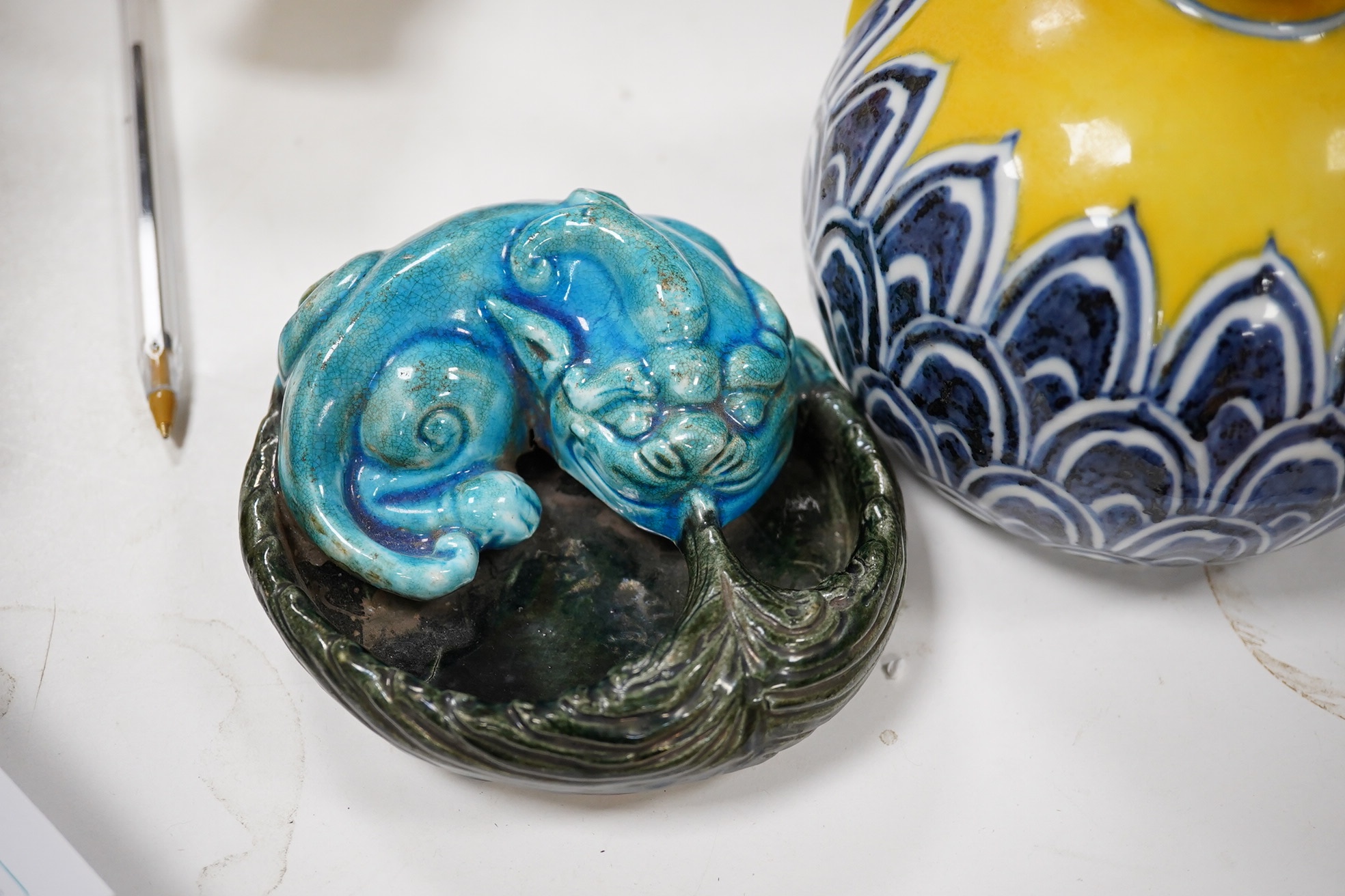 A Chinese yellow ground teapot, Xuande mark but later and a turquoise glazed ‘lion dog’ brush washer, tallest 13cm. Condition - good